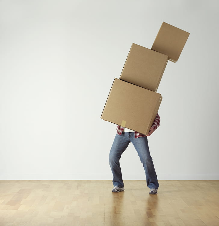 man trying to move boxes out of his empty home before cleaning