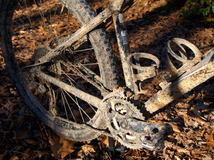 A muddy bike that is in need of a thorough cleaning