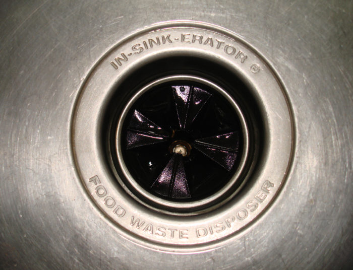 garbage disposal in a stainless steel sink