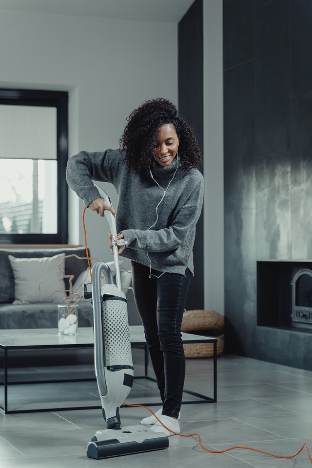 a woman vacuuming her floor