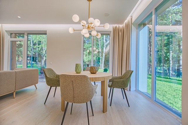 a clean and neat dining room surrounded by windows