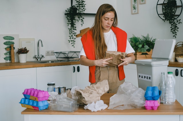 a woman sorting through her recycling