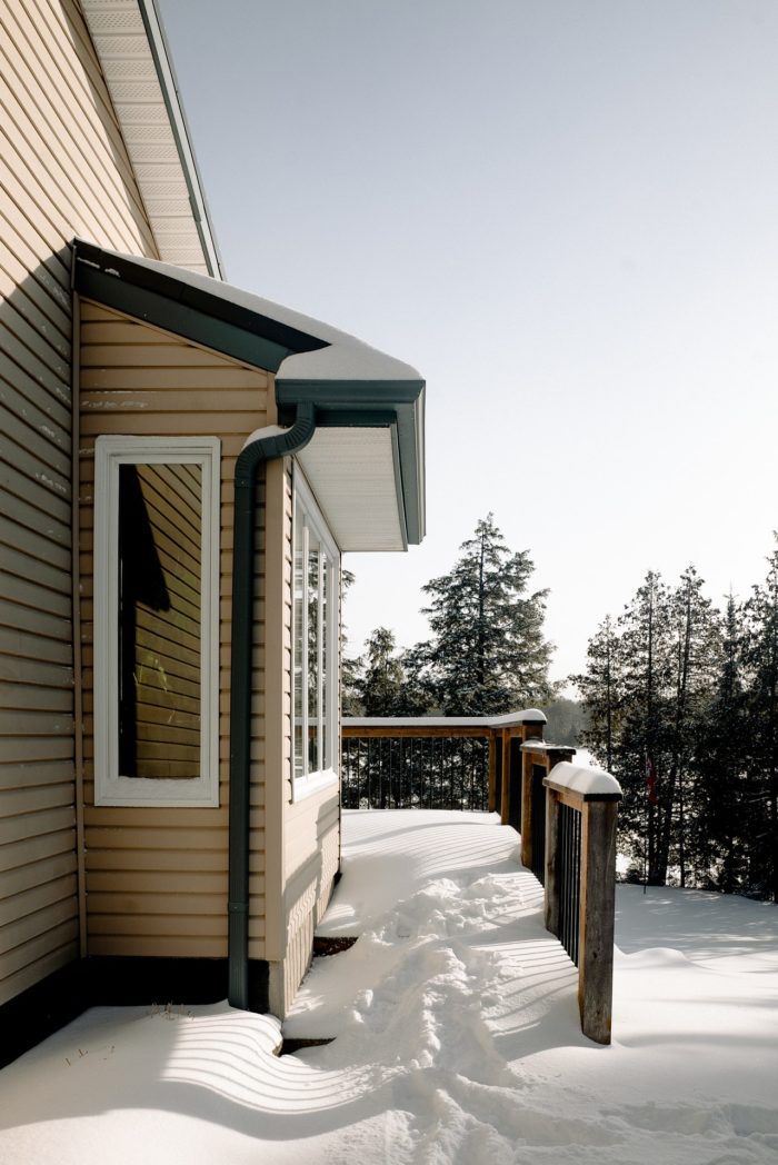 a very snowy walkway to a home