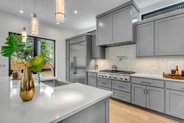 an very clean grey colored kitchen