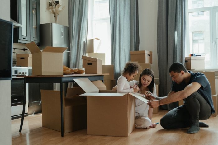 a family packing up to move with many boxes