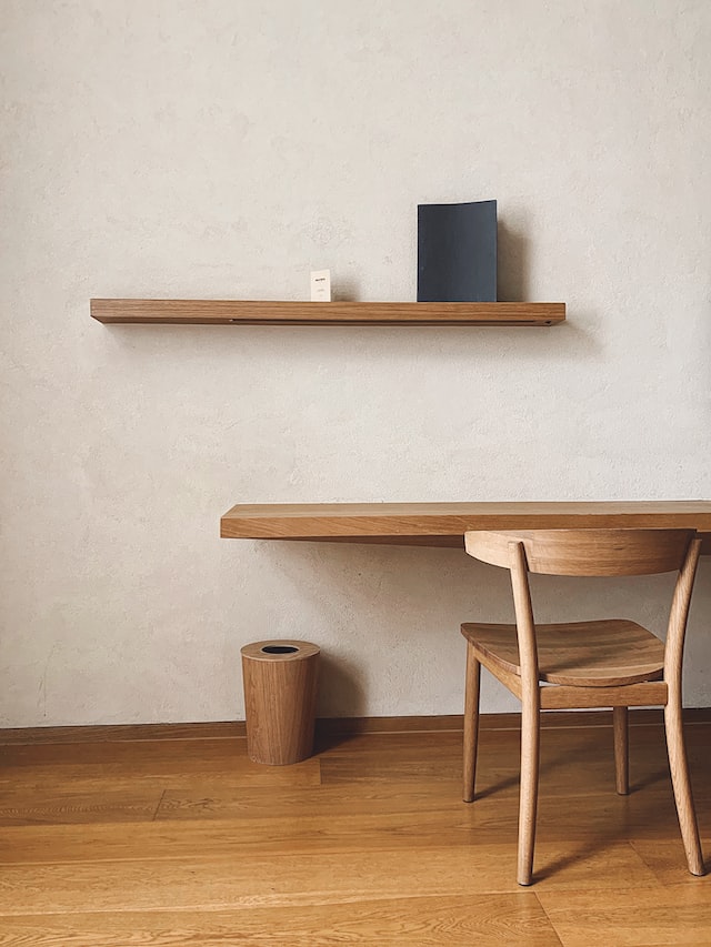 a wood shelf and wood desk and chair