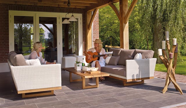 patio with woman playing guitar on outdoor couch